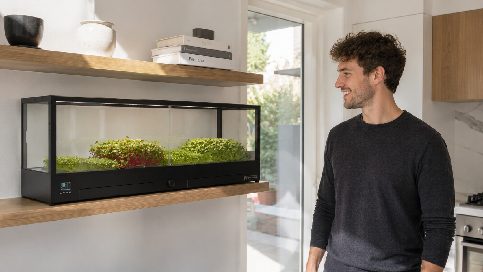 Man standing in front of Minigro, an indoor microfarm